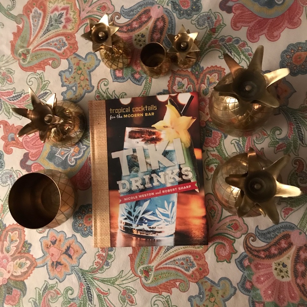 Bar cart-pineapple shakers and tiki cocktail book